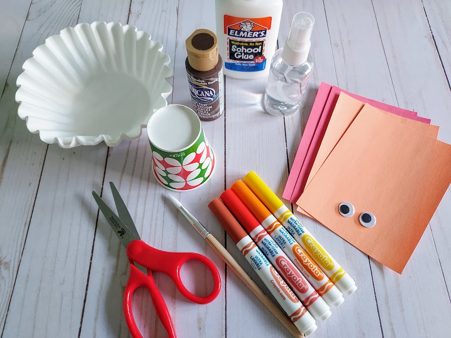 Coffee filters, paper cups, brown paint, liquid glue, scissors, markers, construction paper, and googly eyes.