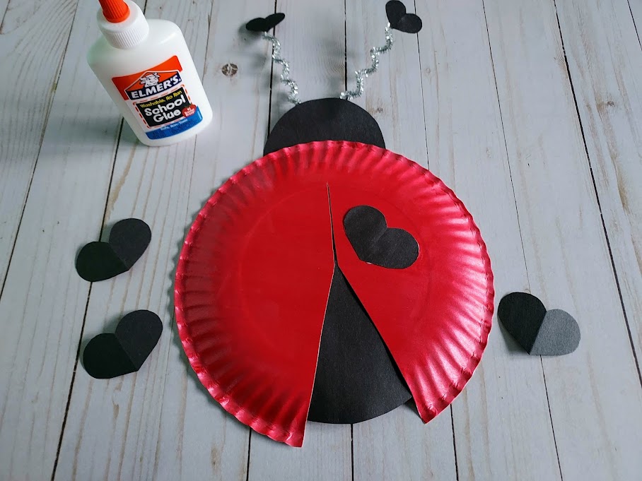 Glue on heart spots to red paper plate.