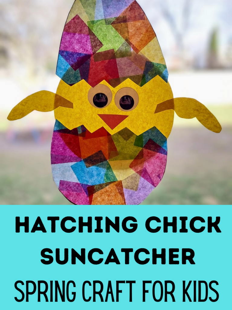 Finished hatching chick suncatcher craft made with tissue paper and construction paper hanging on sunny window.