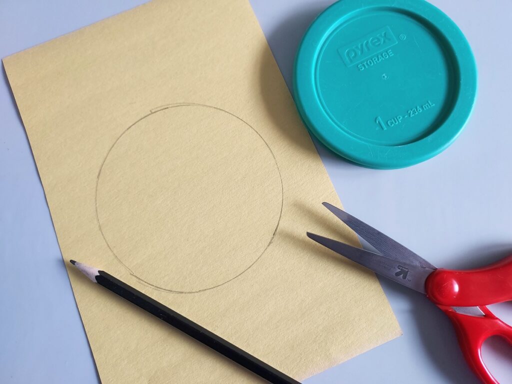 Circle traced on yellow construction paper using a small Pyrex lid.