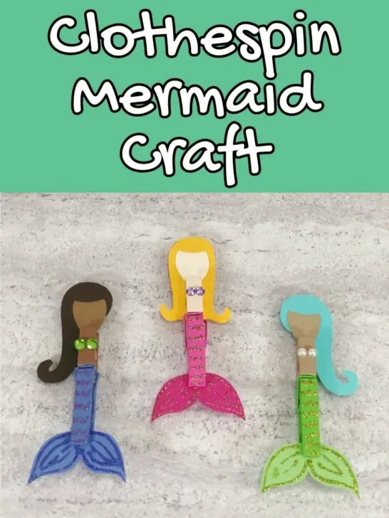 White text outlined with black on green background at top of image says Clothespin Mermaid Craft. Three completed mermaids arranged next to each other. One has dark skin tone, black hair, and dark blue tail. One has light skin, yellow hair, and pink tail. One has light brown skin tone, aqua hair and lime green tail.