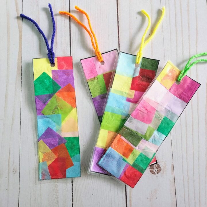 Set of four finished faux stained glass tissue paper bookmarks with yarn tassels.