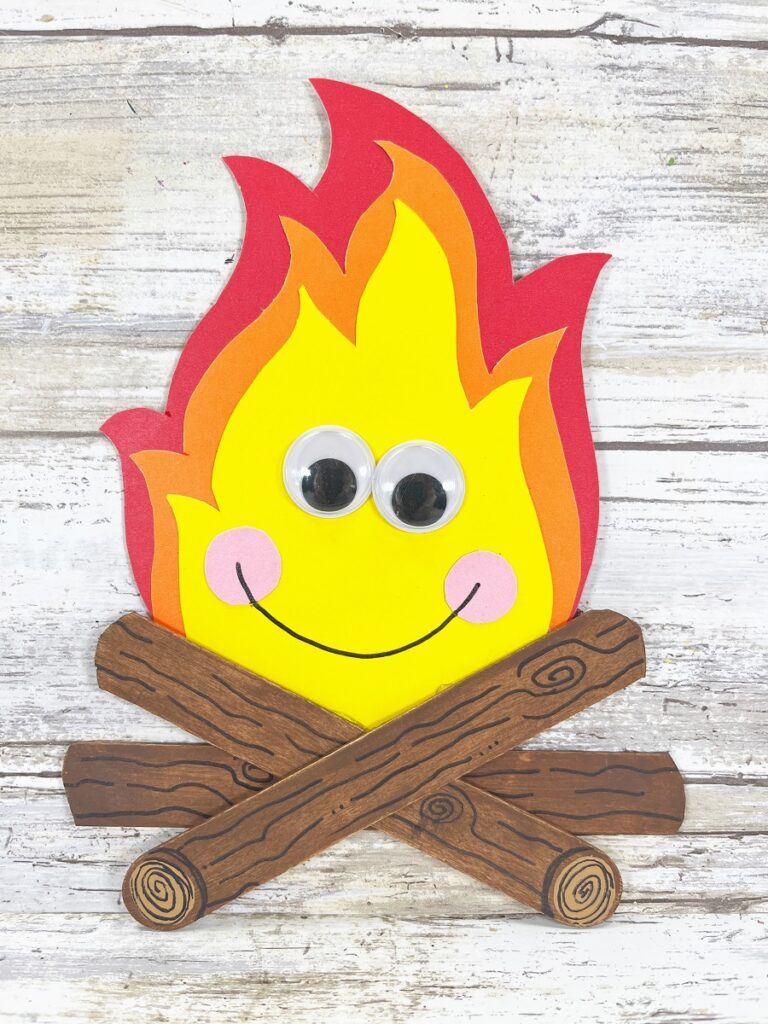 finished popsicle stick campfire craft with cute kawaii face.
