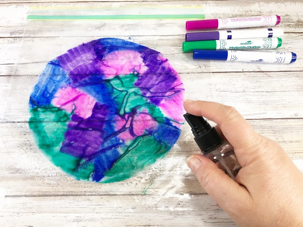 Blending colors by spraying colored coffee filter with water.