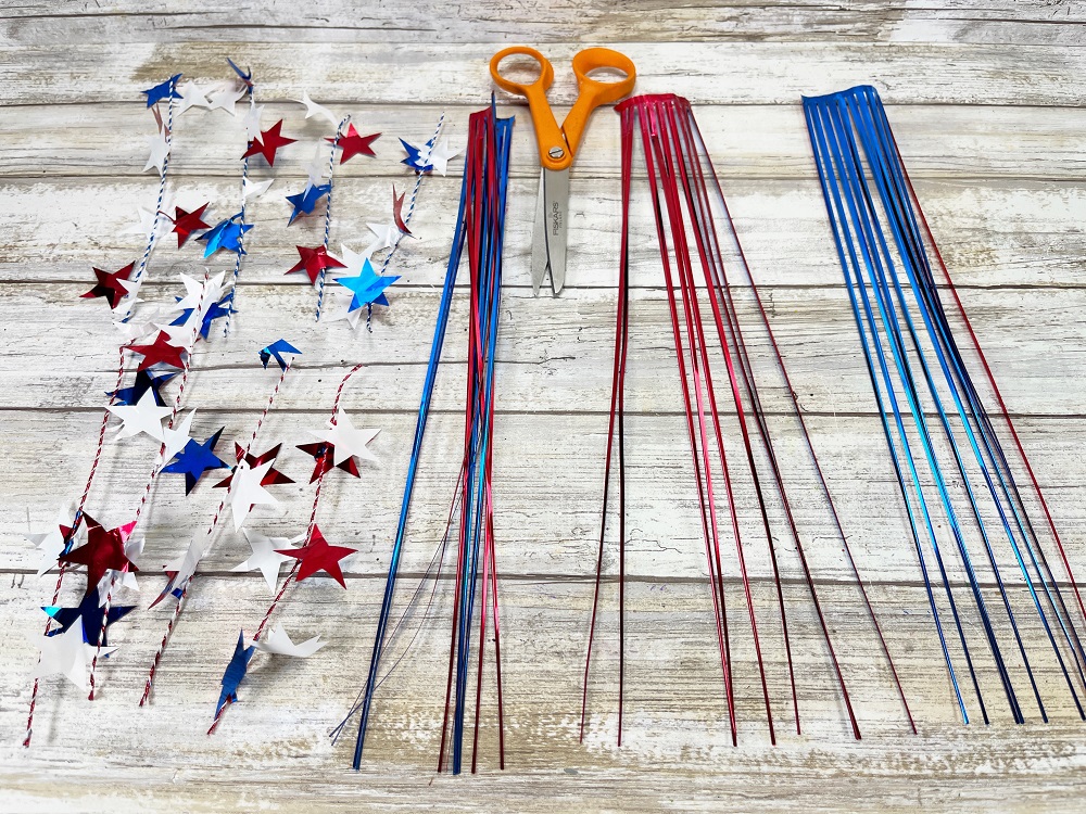 Pieces of red, white, and blue wired star garland and tinsel cut into sections.
