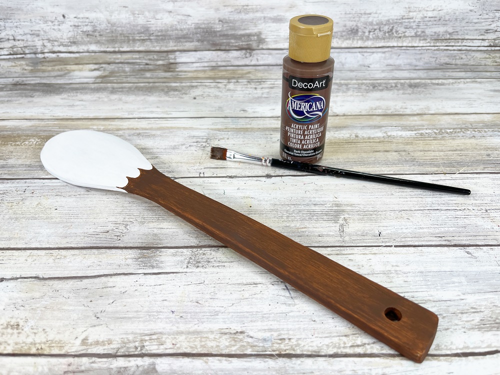 Bamboo cooking spoon painted white and brown to resemble a bald eagle's head and body.