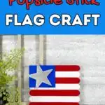 Red and white text on light blue background says Popsicle Stick Flag Craft above a small flag made out of painted craft sticks, blue craft foam, and a glittery wooden star.