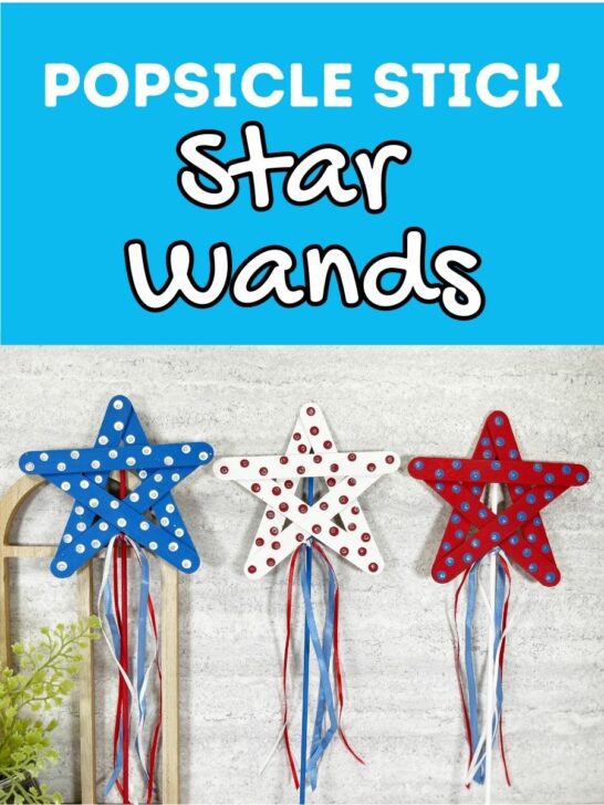 White text on bright blue background says Popsicle Stick Star Wands. Underneath is a photo of three completed star wands made with craft sticks, wooden dowels, paint, and ribbons. They are painted red, white, and blue for 4th of July.