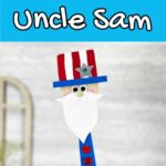 White text on blue background at the top says Wooden Spatula Uncle Sam. Close up view of finished project made using a flat bamboo spatula, craft foam, and paint.