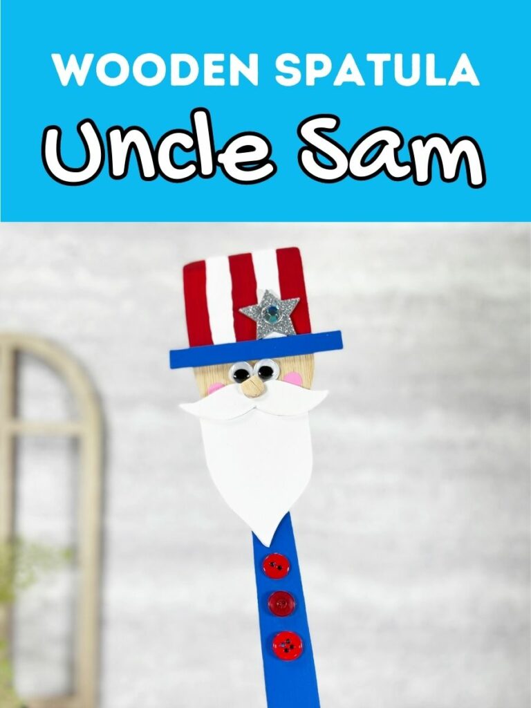 White text on blue background at the top says Wooden Spatula Uncle Sam. Close up view of finished project made using a flat bamboo spatula, craft foam, and paint.