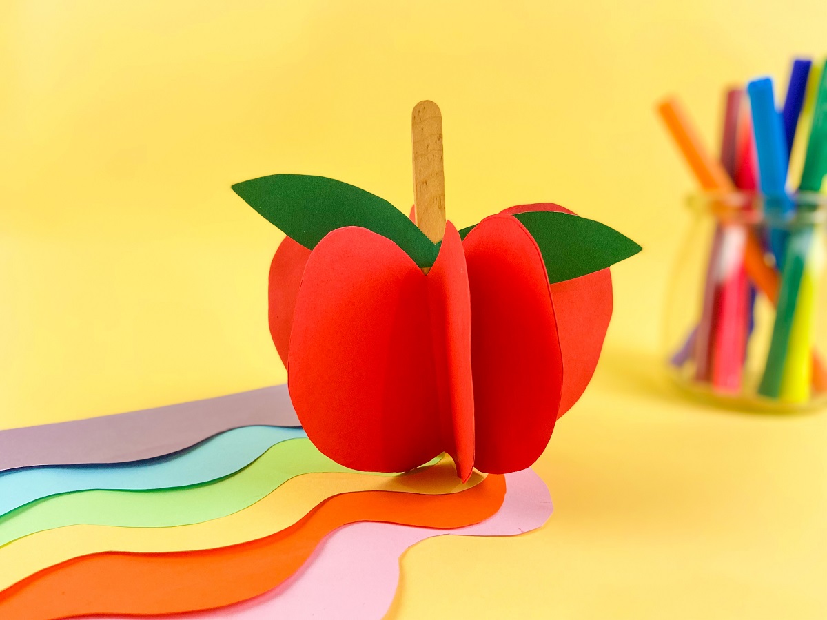 Side view of 3D apple made with red paper.