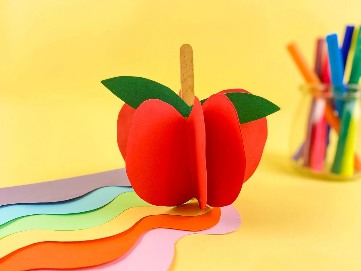 Side view of 3D apple made with red paper.