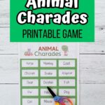White and black text on a green rectangle at the top says Animal Charades Printable Game. Below is a photo of a sheet of charades cards with animals printed out and a pair of scissors laying on it.