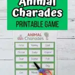 White and black text on a green rectangle at the top says Animal Charades Printable Game. Below is a photo of a sheet of charades cards with animals printed out and a pair of scissors laying on it.