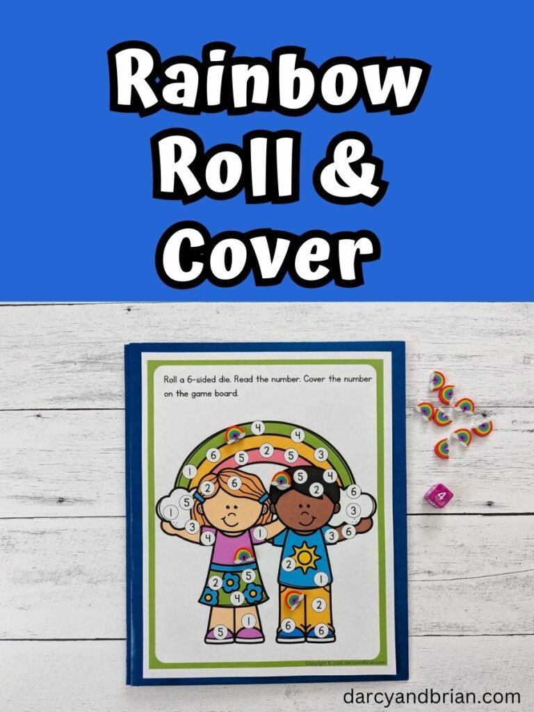 White text on dark blue background at the top says Rainbow Roll & Cover. Underneath is a photo of the game printed out on a piece of paper, laying on top of a blue folder. There is a six sided die and mini rainbow erasers too.