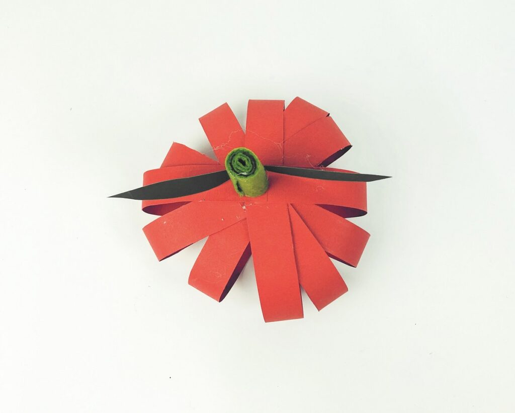 Green stem and green leaf glued to the top of the paper strip apple.