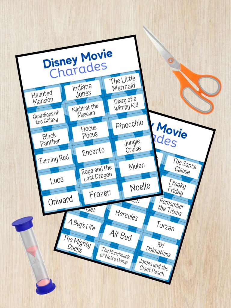 Mockup showing two of the pages from the Disney Movie Charades printable game overlapping on a desk. A pair of scissors and a sand timer are next to the page preview.