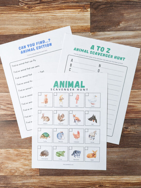 All three animal scavenger hunts printed out and overlapping on a table.