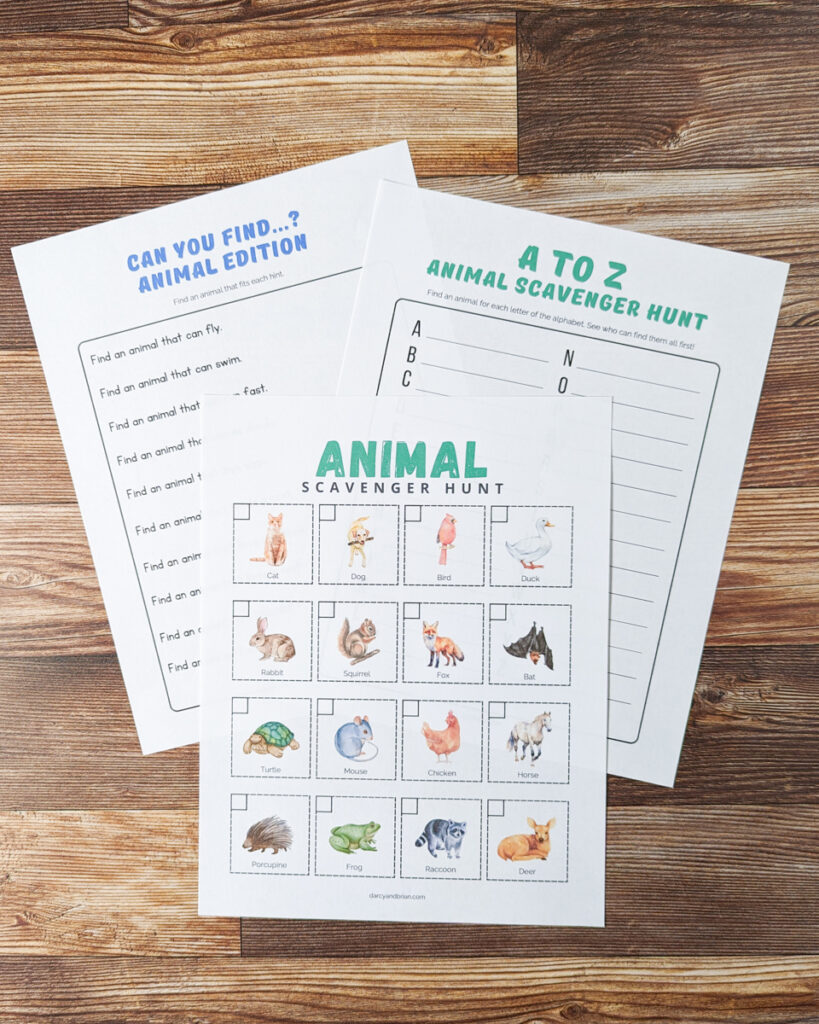 All three animal scavenger hunts printed out and overlapping on a table.