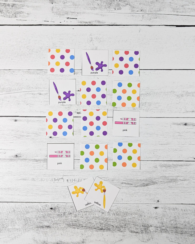 Several cards laid out in a grid. Matching purple paint and matching pink marker cards are flipped over.