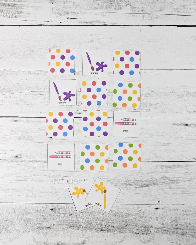 Several cards laid out in a grid. Matching purple paint and matching pink marker cards are flipped over.