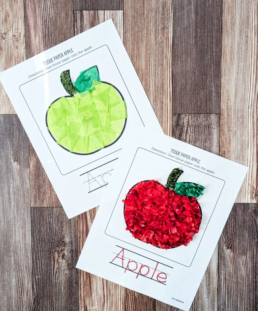 Two complete tissue paper apple crafts. Each sheet of paper is tilted and they overlap slightly. One apple is made with green tissue paper and the other is made with red crumpled tissue paper.