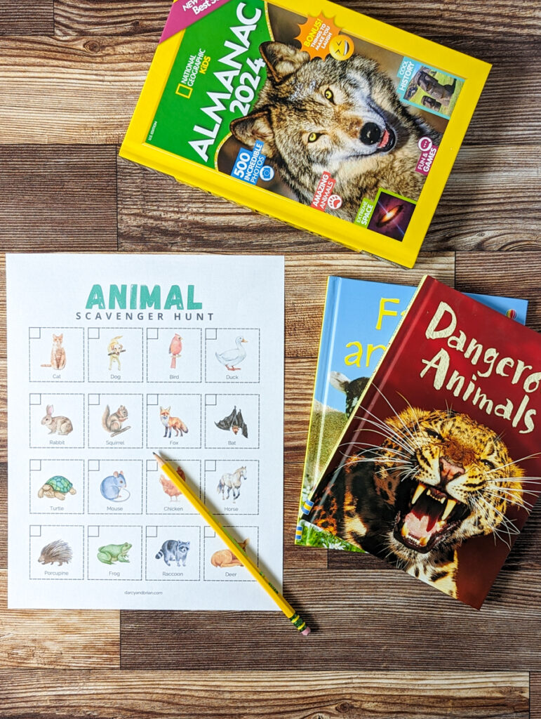 Visual scavenger hunt page laying next to three books about animals. A pencil is laying diagonally on the page.