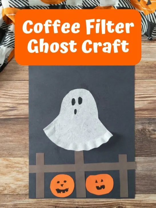 Completed coffee filter ghost craft on construction paper.
