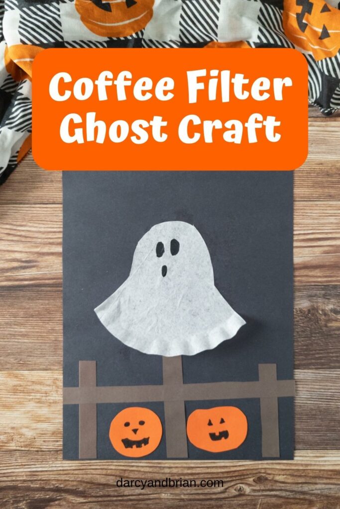 Completed coffee filter ghost craft on construction paper.