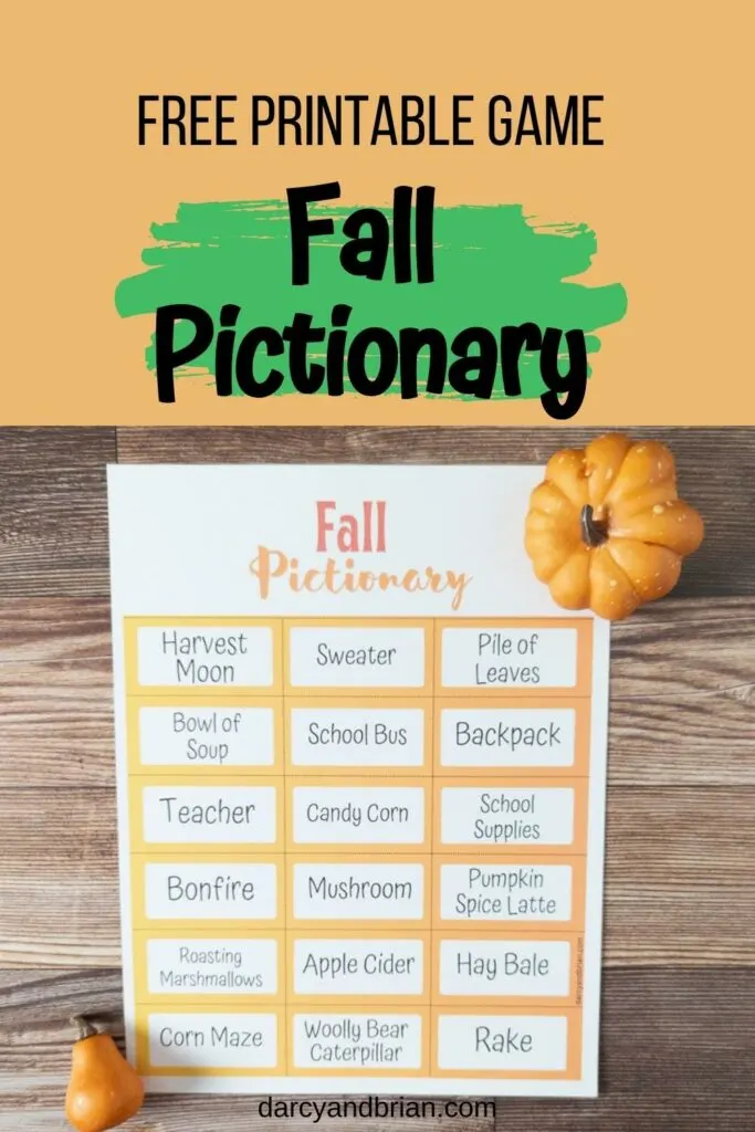 Top part of image has black text on orange and green background that says Free Printable Game Fall Pictionary. Below that is a photo of a sheet of prompt cards on a table. A decorative little pumpkin and gourd nearby.