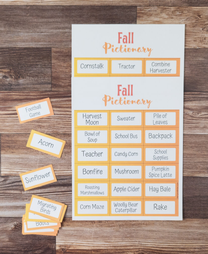 Overhead view of printed out pages with fall themed drawing prompts. Some cards are cut out and lay scattered next to the full sheets on the table.
