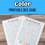 White and black text on blue background at the top of image says Roll & Color Printable Dice Game. Bottom half of image is a photo of two pages printed and fanned out on table with dice and crayons next to them.