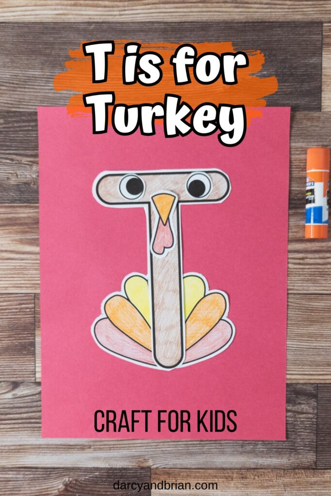 White text on an orange brush stroke background says T is for Turkey just above completed craft project. Bottom says Craft For Kids in black text.