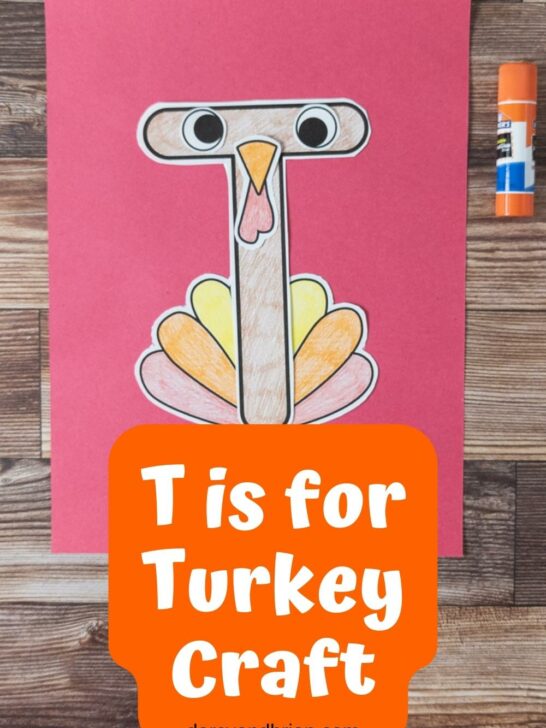 Paper pieces assembled to create a turkey and using a T shape as the body on a piece of red construction paper. White text on orange near bottom says T is For Turkey Craft.