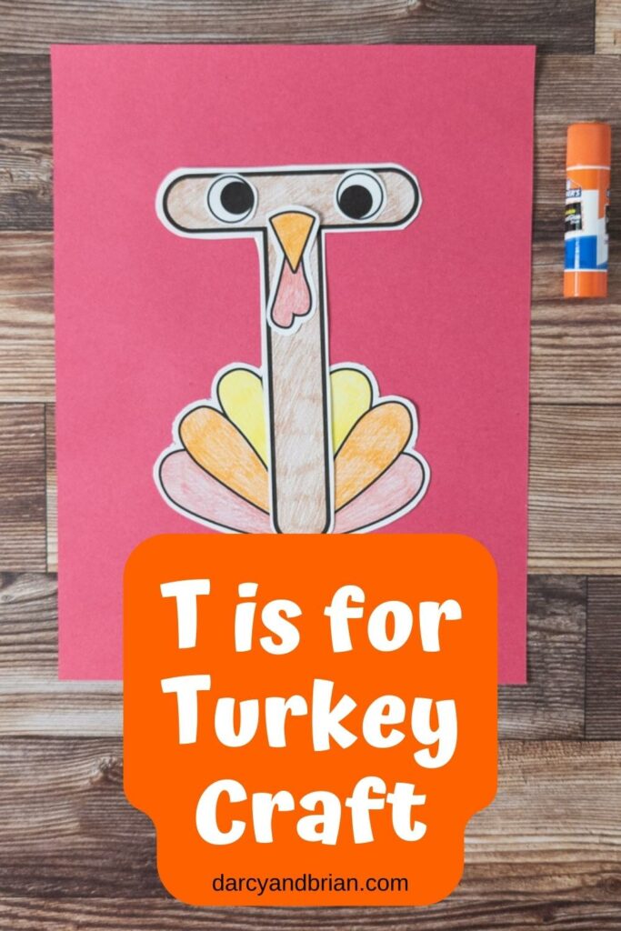 Paper pieces assembled to create a turkey and using a T shape as the body on a piece of red construction paper. White text on orange near bottom says T is For Turkey Craft.