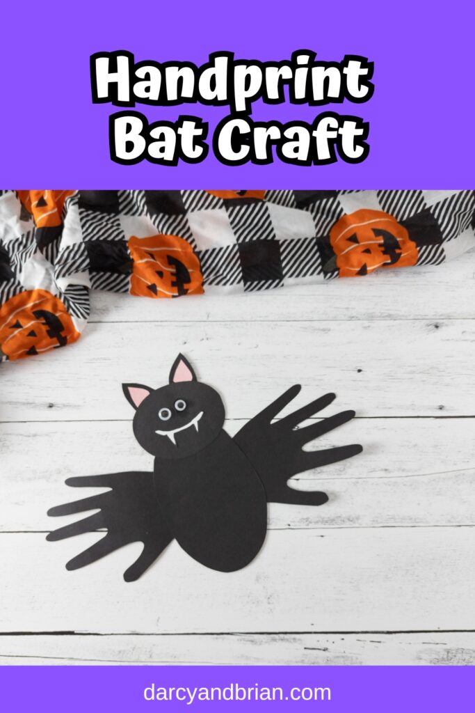 White text on purple background at top says Handprint Bat Craft. Photo of bat made out of black paper using handprints for wings.