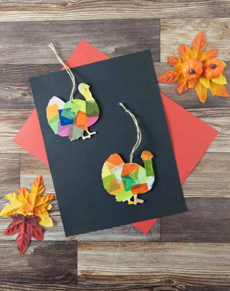 Tissue paper painted turkey cutouts with twine to hang them up.