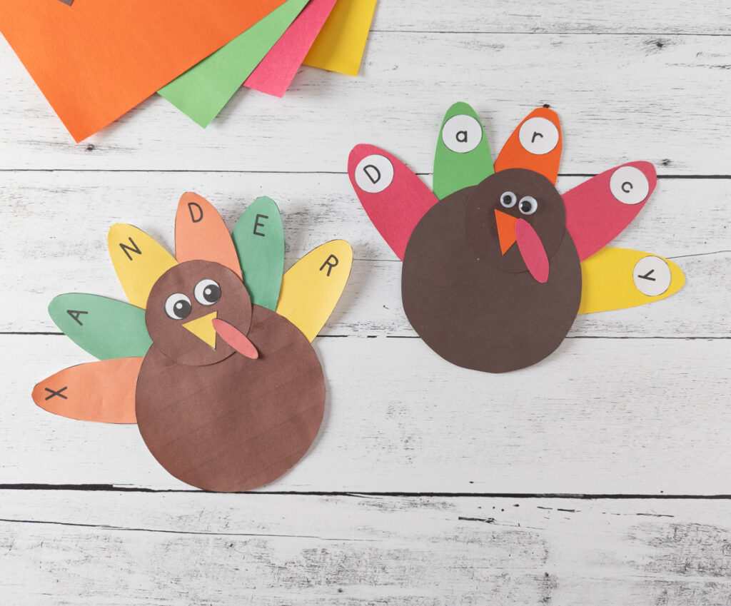 Two complete paper turkey name crafts beside each other. One made from the full color printables and one made with construction paper.