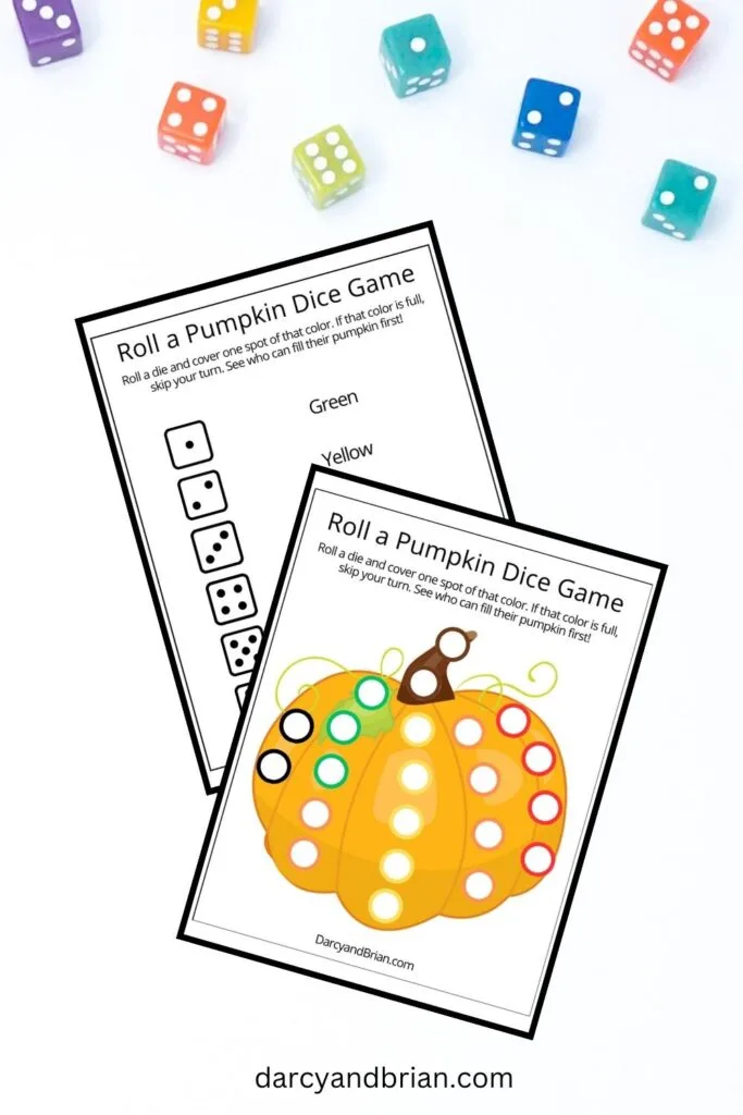 Full color roll a pumpkin game mat and the dice color key overlapping on a background with colorful six sided dice scattered along the top.