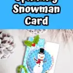 White text on blue background at the top says Spinning Snowman Card. Mockup of completed Christmas card on a snowy background.