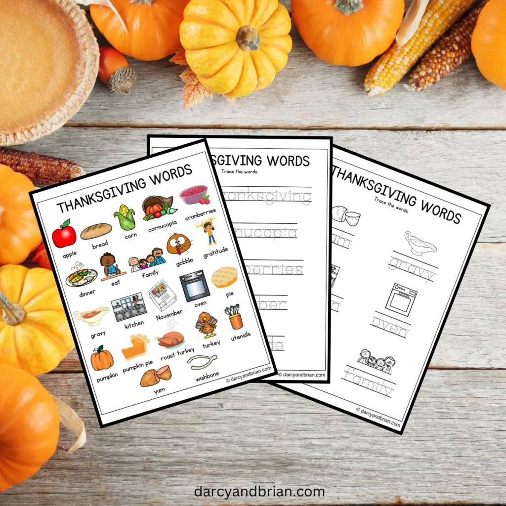 Mockup of color version of Thanksgiving words and pictures plus two tracing pages on a background with pumpkins and pie.