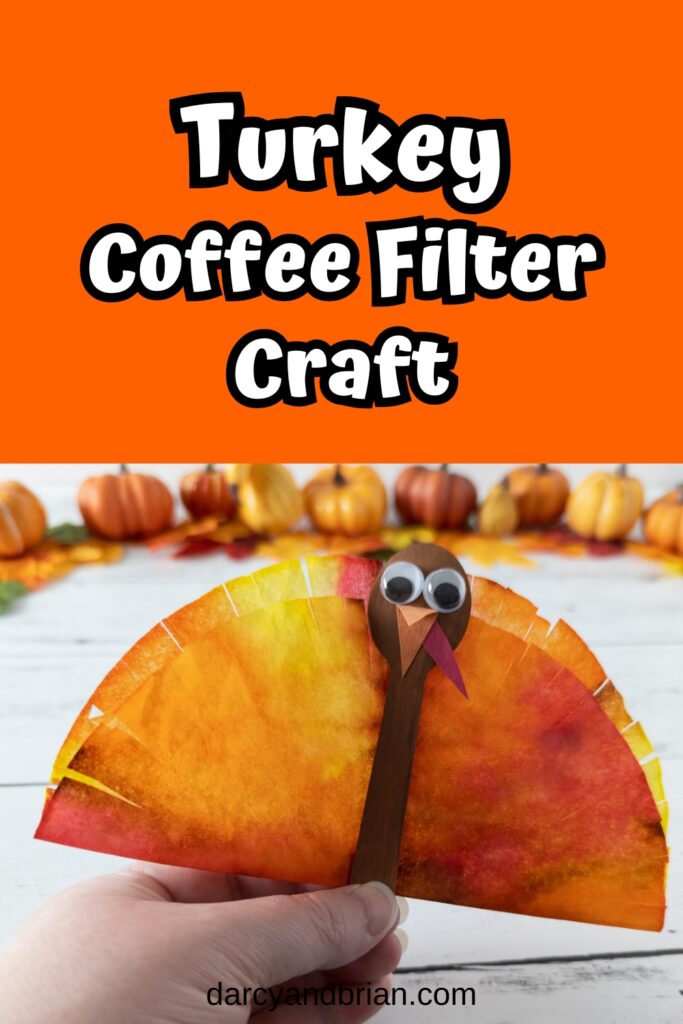 White text outlined with black on an orange background at the top says Turkey Coffee Filter Craft. Photo shows white woman's hand holding up a completed turkey made out of coffee filter and mini wooden spoon.