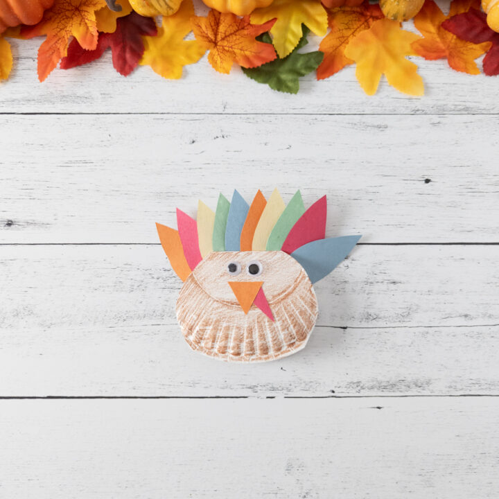 Finished easy rocking turkey craft made with paper plate and construction paper.