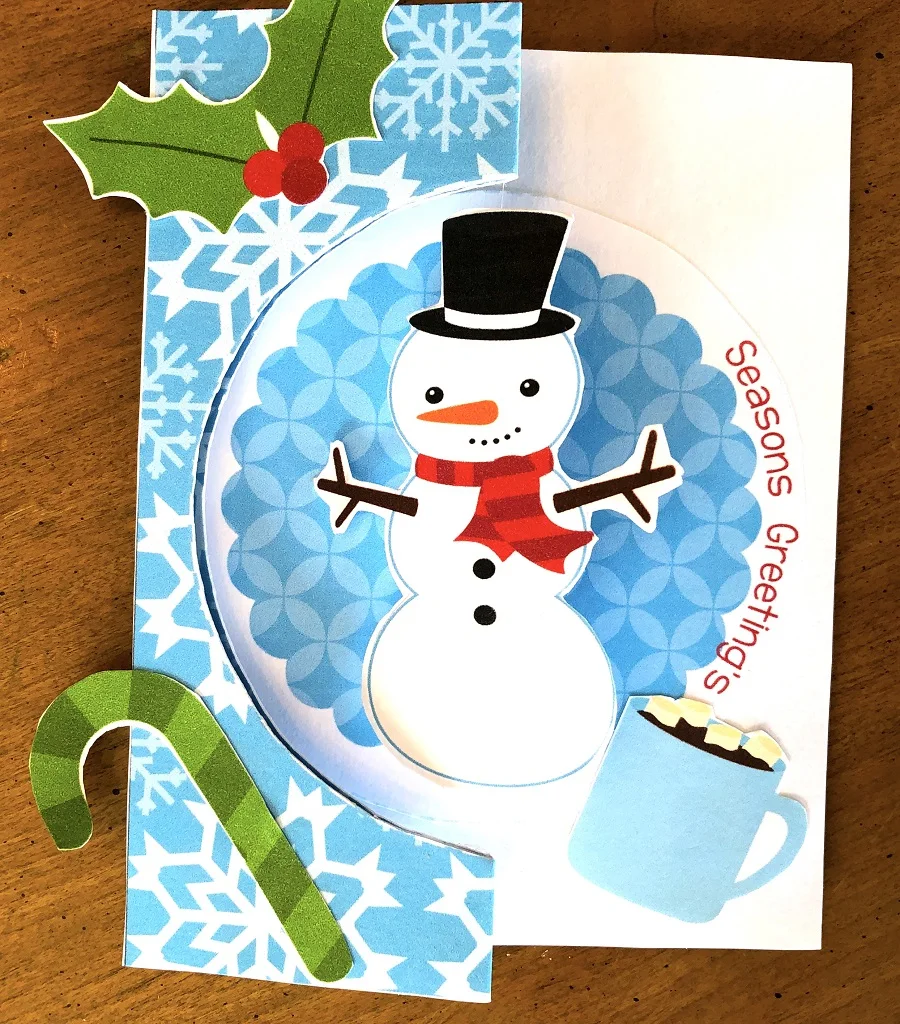 Completed Christmas card craft with a spinning snowman.