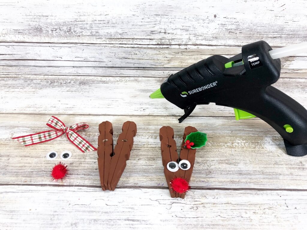 Adding face and embellishments to reindeer clothespin craft.