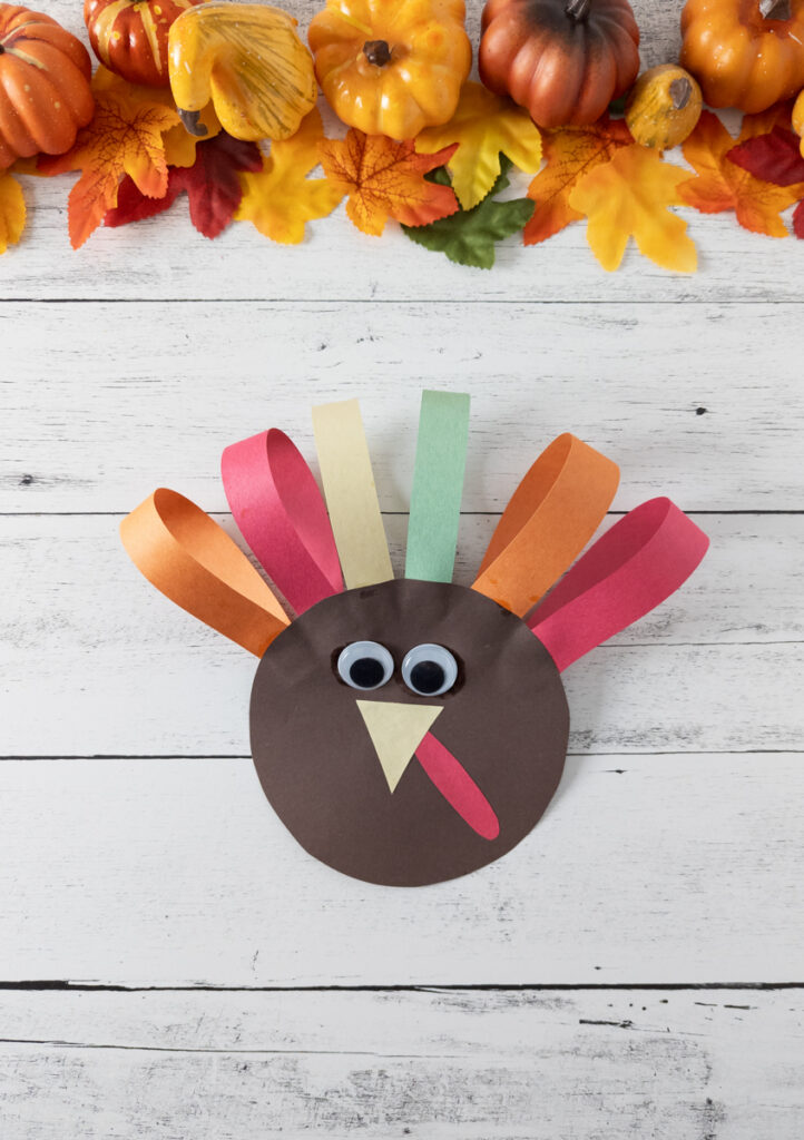 Finished paper turkey craft with colorful paper loops for feathers.