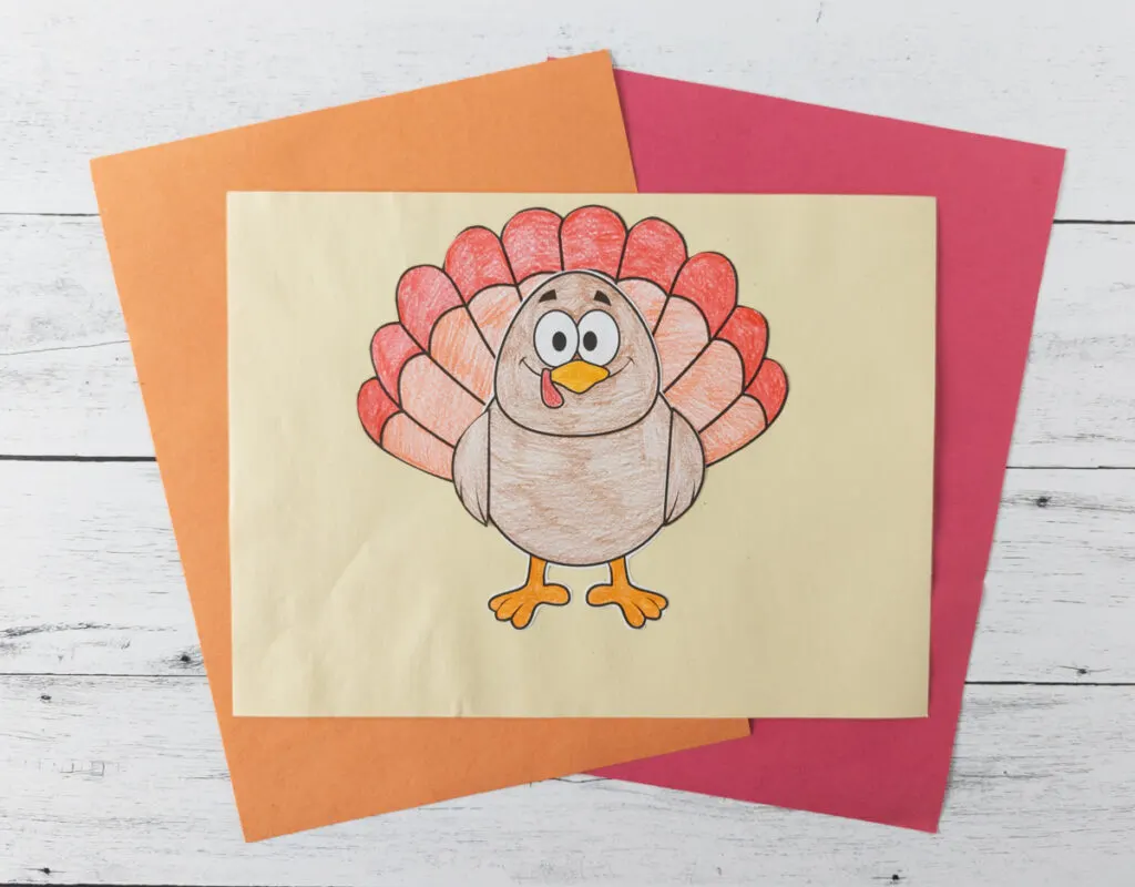 Finished turkey craft colored in with crayon, cut out, and glued to light yellow construction paper.