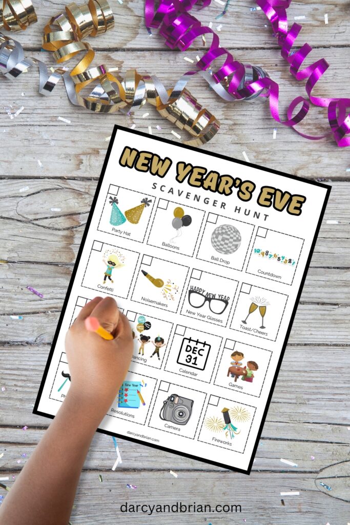 Mockup of checklist picture scavenger hunt of New Year's Eve items and a child's hand holding a pencil.