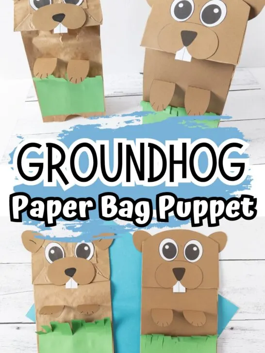 Finished groundhog puppet crafts made with paper bags and looking like they are peeking out of the grass.