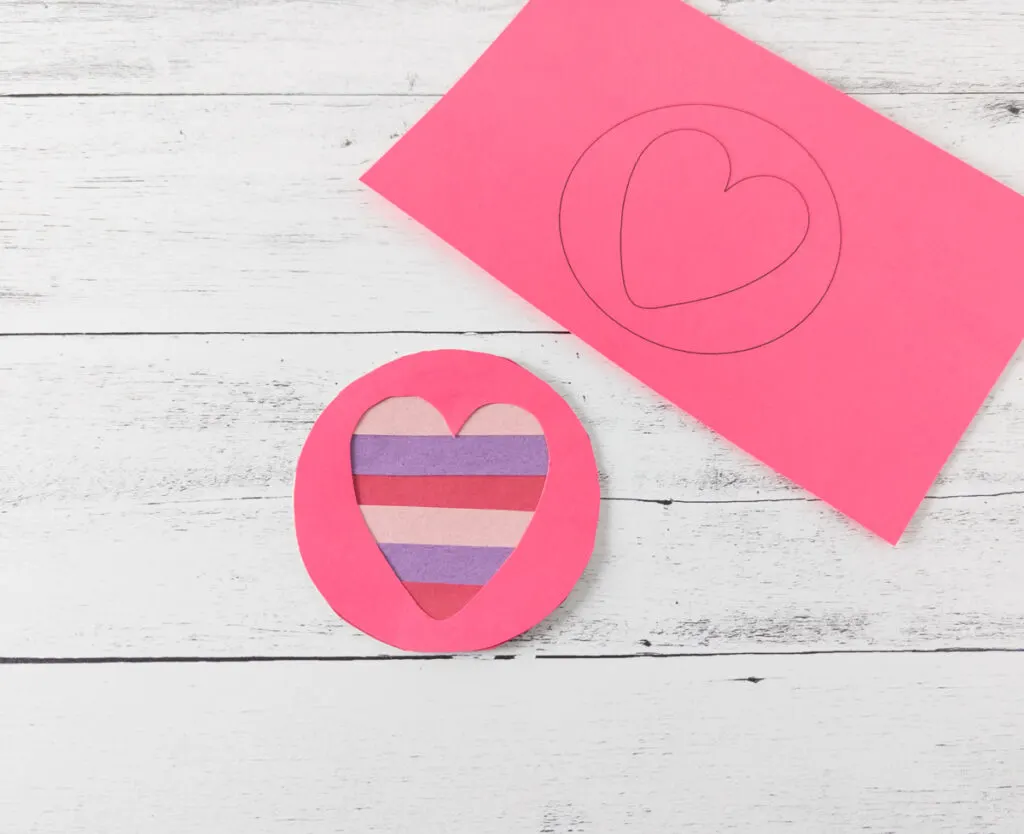 Small heart craft made using a paper plate, construction paper strips and printable template.